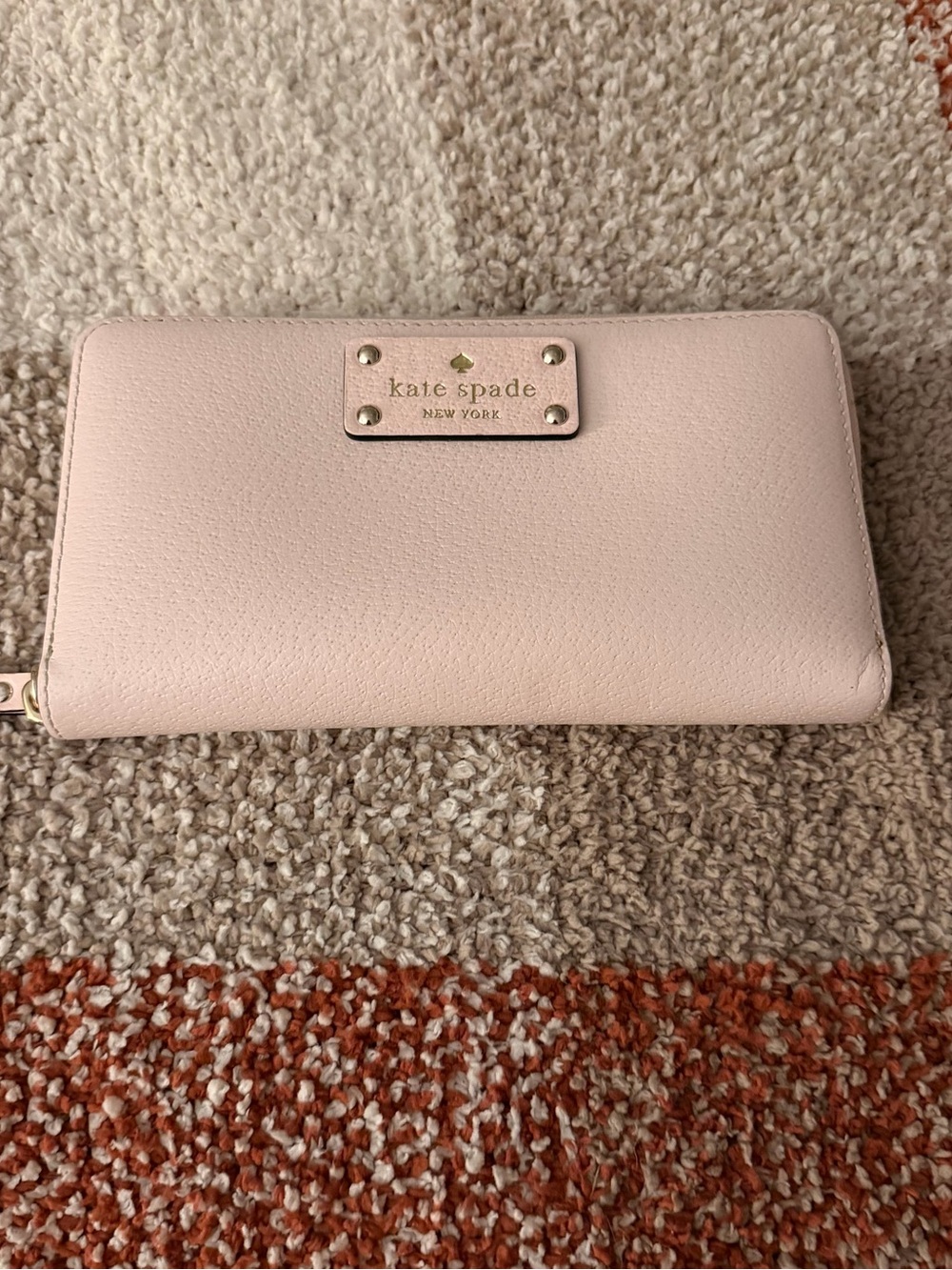 kate spade pale pink zip-around wallet with metal logo plaque